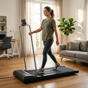 Woman walking on the folding treadmill at home